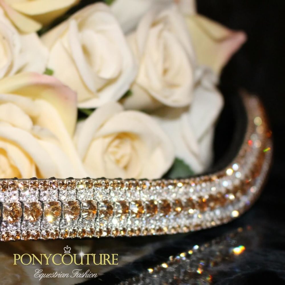 gold tone crystal browband on a black back ground with cream flowers and in five rows of preciosa crystal browbands