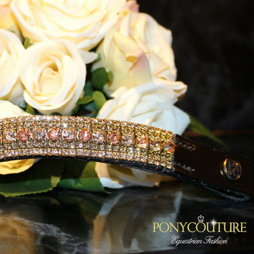 the side of a handmade crystal browband in an alternating design with light peach and crystal apricot with PonyCouture sheild bridle badge to left loop and is for dressage and dressur with showjumping and pferd and cheval horse in mind